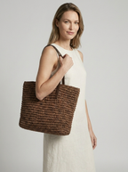 Women's woven straw beach bag with a braided design