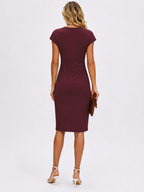 Woman wearing a burgundy dress on a white background