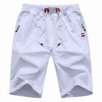 Men's white training shorts with a drawstring waist and zip pockets