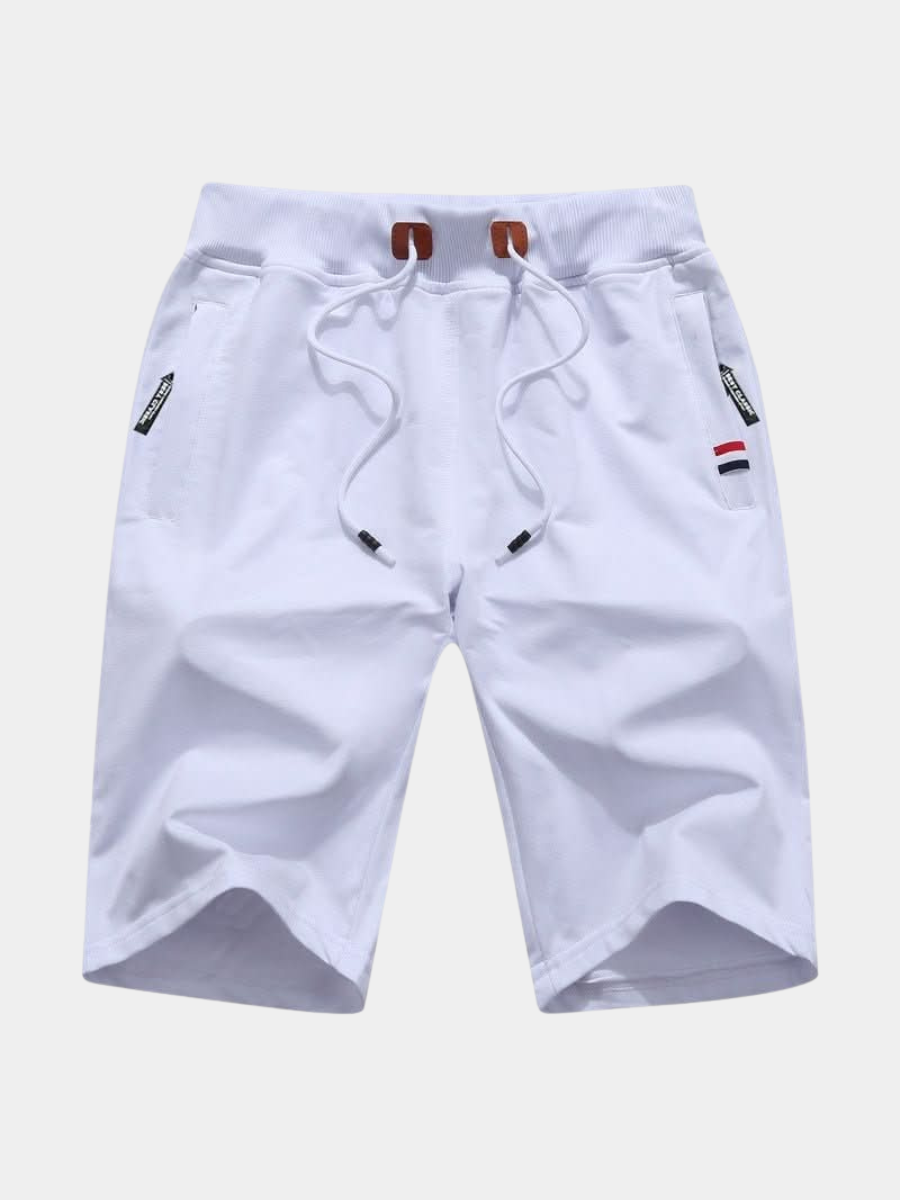 Men's white training shorts with a drawstring waist and zip pockets