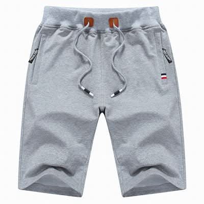 Men's white training shorts with a drawstring waist and zip pockets