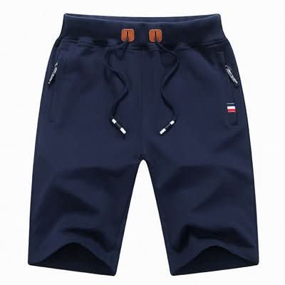 Men's white training shorts with a drawstring waist and zip pockets