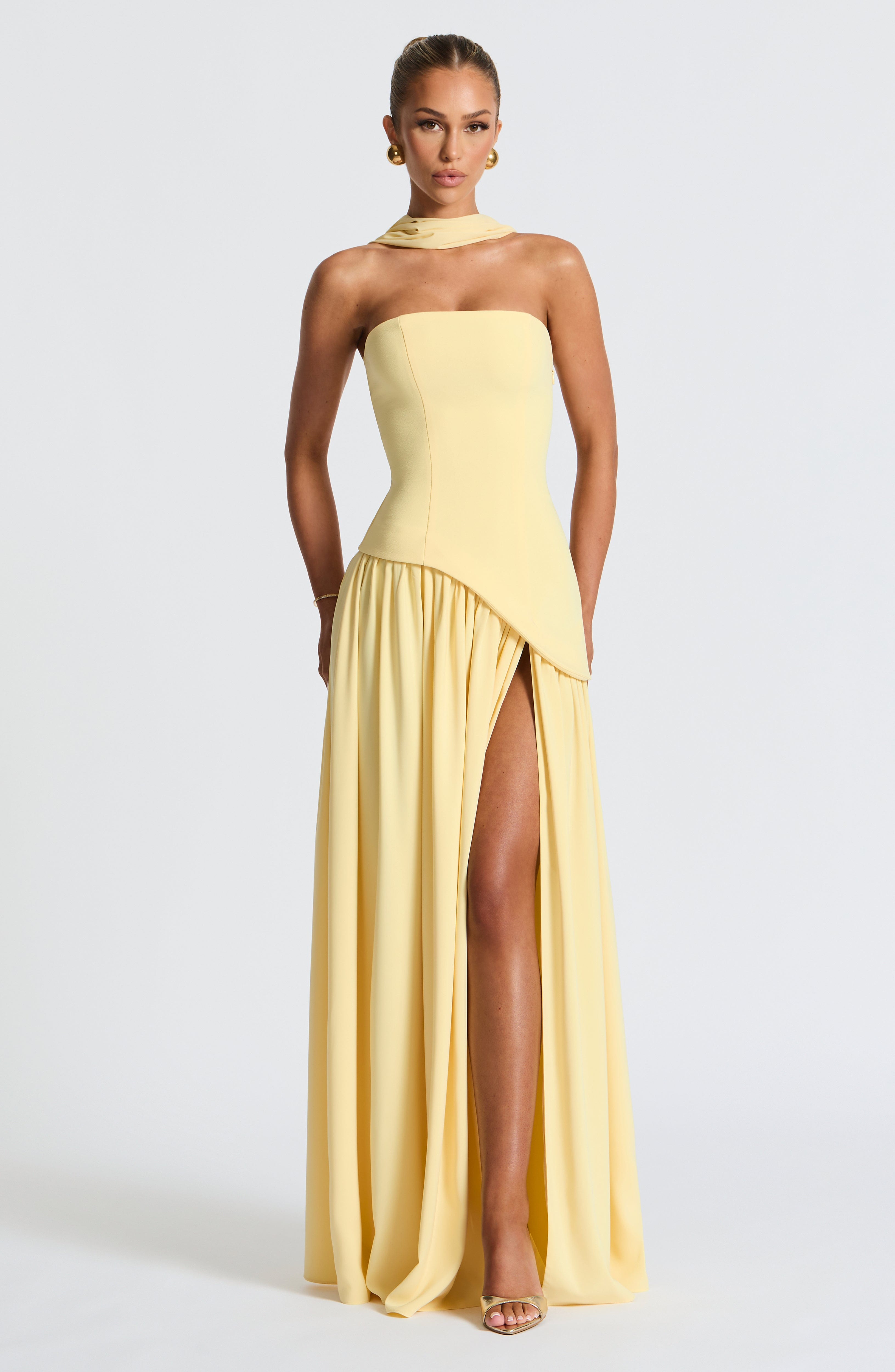 Women's yellow strapless maxi dress with a high front split