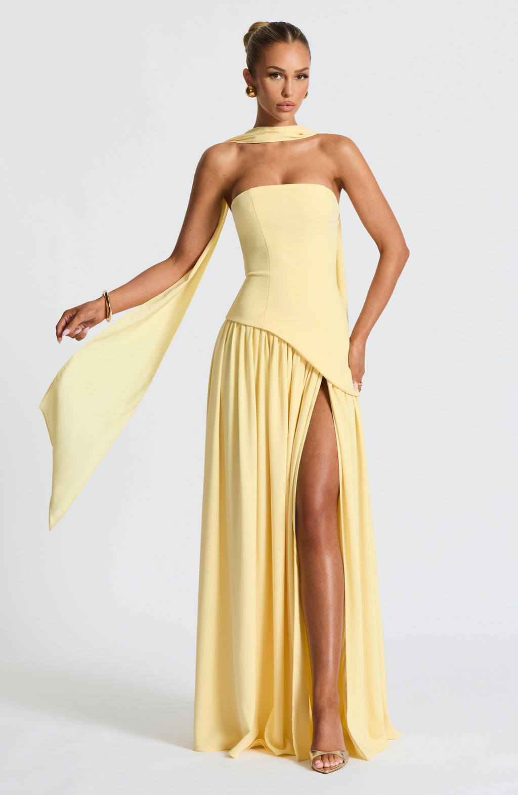 Women's yellow strapless maxi dress with a high front split