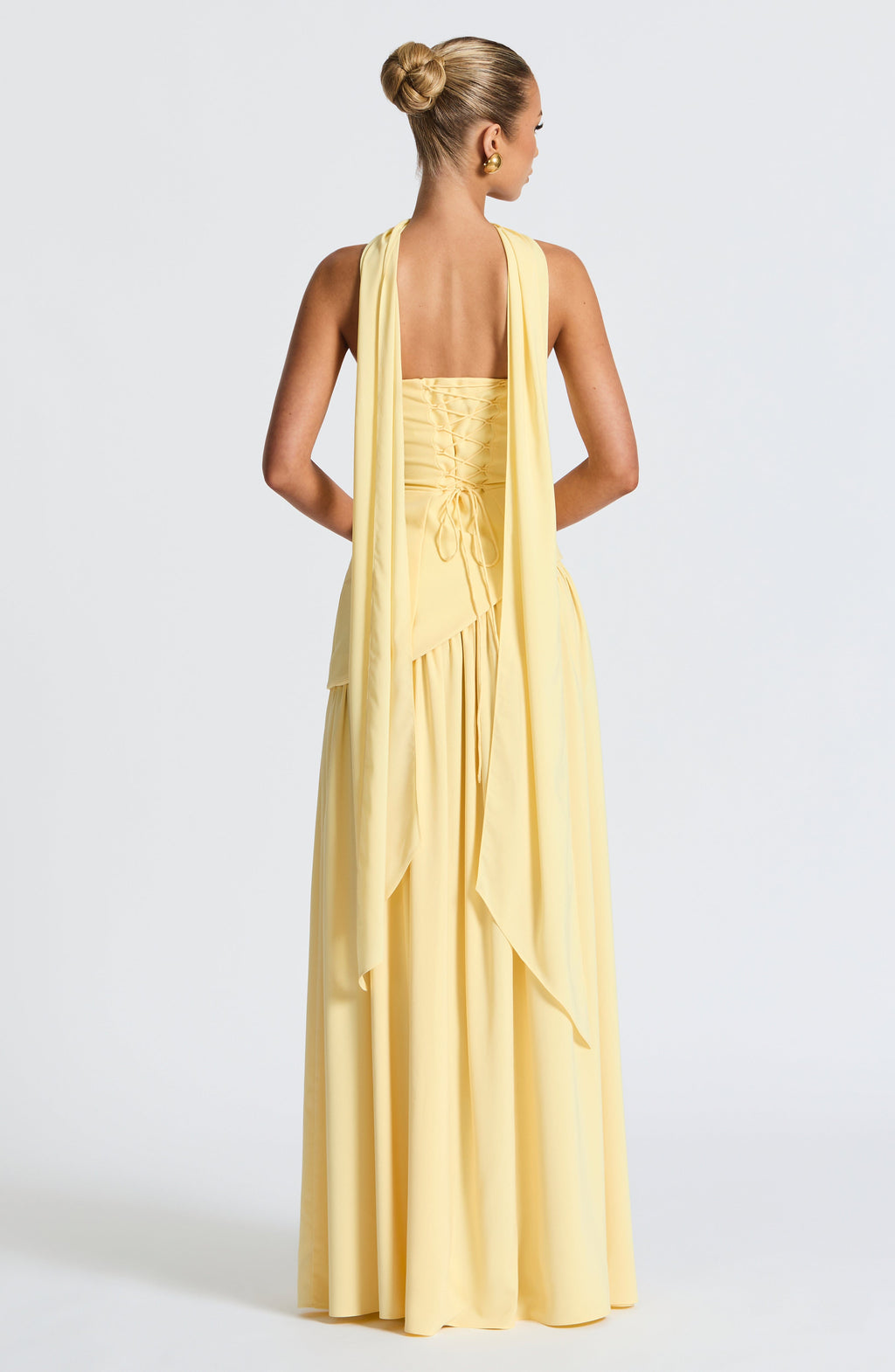 Women's yellow strapless maxi dress with a high front split