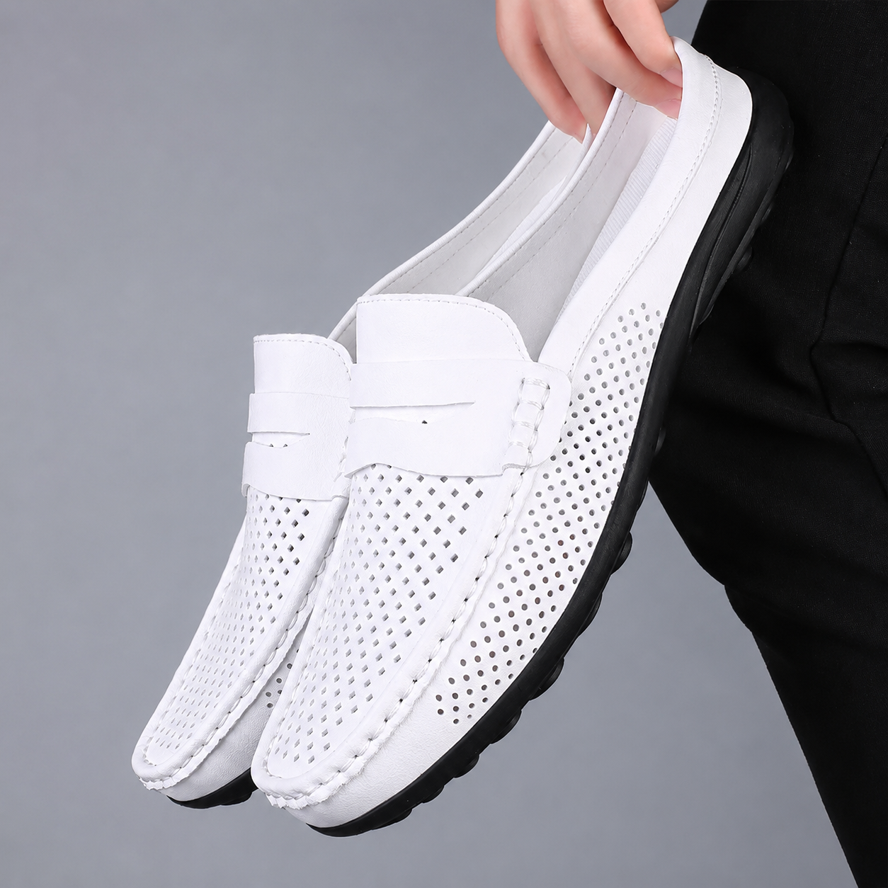 Men's black perforated slip-on loafers with a flexible sole