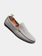 Men's grey slip-on canvas loafers with a flexible sole